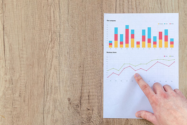 person pointing to a graph